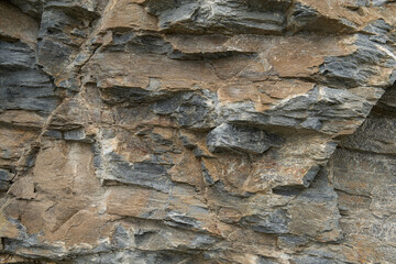 Geological layers of a rough structured stone in a  full frame image