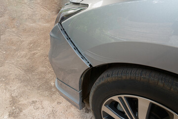 Fototapeta na wymiar Car crash or accident. Front fender and light damage on bumper. Broken vehicle detail of Private car , close up.