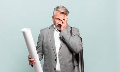 senior architect feeling bored, frustrated and sleepy after a tiresome, dull and tedious task,...