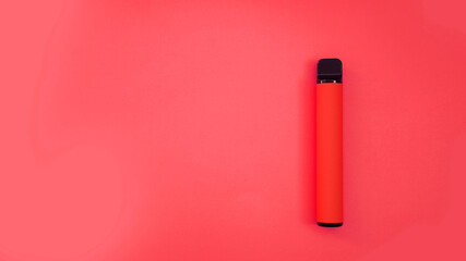 Red disposable electronic cigarette on bright red background