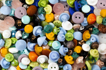 Colorful bright buttons background. Old vintage buttons close-up. Copy space. Top view. Background of buttons. Flat lay.