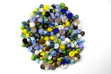 Colorful bright buttons on a white background. Old vintage buttons close-up. Copy space. Top view. Background of buttons. Flat lay.