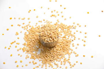 Unpolished Pigeon pea also known as toor dal in a metal bowl. Isolated on white background.