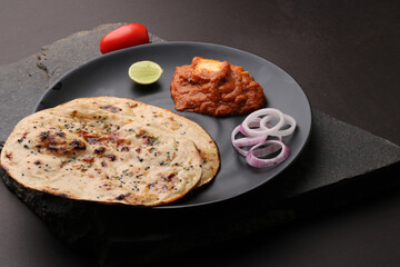 Paneer Butter Masala or Cheese Cottage Curry  served with naan or tandoori roti.