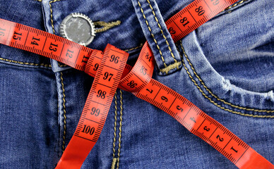 Red meter measuring tape in jeans. Slimming concept