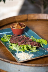 Tasty fresh Tagliatta Steak served with grilled vegetables, rucola