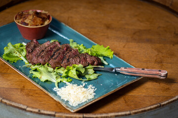 Tasty fresh Tagliatta Steak served with grilled vegetables, rucola