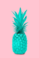 Design turquoise blue pineapple fruit standing on a pink background