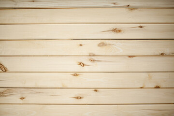 Fototapeta premium The background is a wall made of wooden beams.Texture for your design. Wooden beam and board. Background for still life. Beautiful wood texture. 