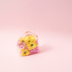 Colorful flowers in transparent plastic bag.