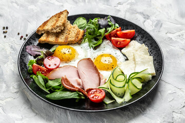 English breakfast toast, egg, bacon and vegetables. Delicious breakfast or snack on a light background, top view