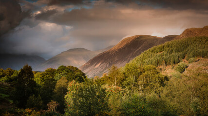 Sunset over Ennerdale in Lake District, Cumbria, UK.Dramatic sky and evening light over a beautiful mountain valley.Tranquil landscape scenery.