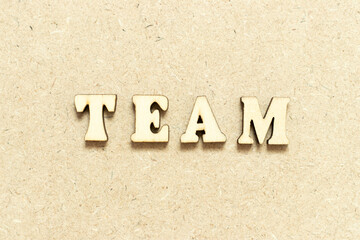 Alphabet letter in word team on wood background