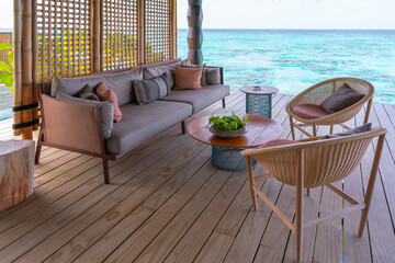 Luxurious exterior of a very expensive rich water villa in the Maldives, decorated with natural wood.