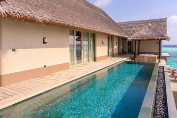 Luxurious exterior of a very expensive rich water villa in the Maldives, decorated with natural wood.