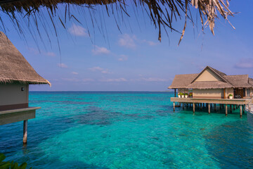 Luxurious exterior of a very expensive rich water villa in the Maldives, decorated with natural wood.