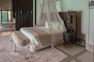 Luxurious interior of a very expensive rich water villa in the Maldives, decorated with natural wood.