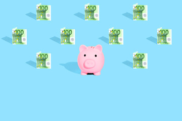 . Euro currency banknotes pattern and pink piggy bank on bright blue background. The concept of financial savings and different transactions.