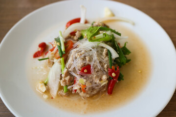 Spicy noodle vermicelli in white plate. Spicy grass noodle salad is Thai food. Food concept