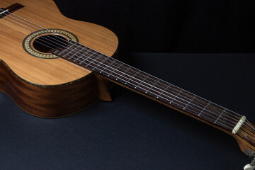 Obraz na płótnie Canvas Guitar on a black background. Acoustic guitar on a dark background. Classical spanish guitar