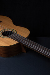 Obraz premium Guitar on a black background. Acoustic guitar on a dark background. Classical spanish guitar