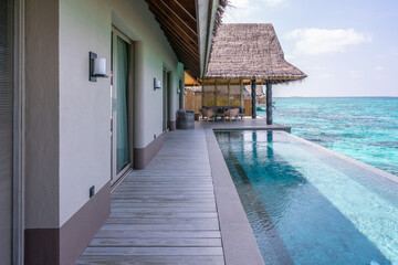 Luxurious exterior of a very expensive rich water villa in the Maldives, decorated with natural wood.