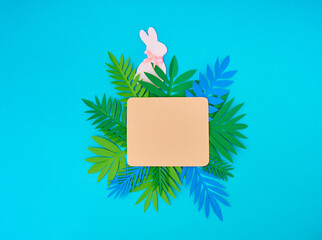 Easter greeting card. Paper blank on blue background. Flat lay, top view, copy space.
