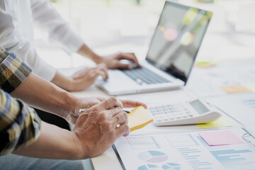 Startup business people teamwork calculating a valuation in workplace..