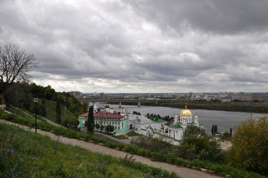 Panoramic view from the high bank of the river, the large bridge and city buildings.