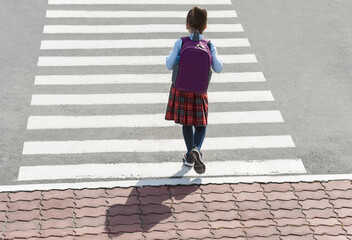 Stylish young teen girl walking with backpack. Active child. Kid runs across the crosswalk. Way forward. Direction to success. Positive thinking. Symbol of overcome obstacles and challenge. Top view