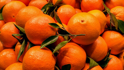 Bright oranges are sold in the central market of Valencia. Close up of a ripe fresh oranges.
