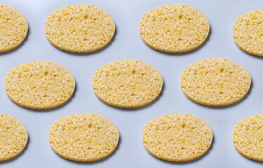 Yellow sponges fopr face on the blue surface.Beauty background