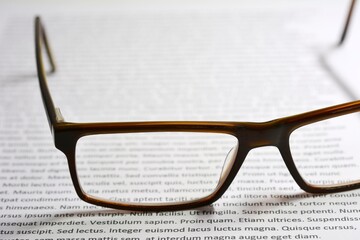Eyeglasses on paper with lorem ipsum