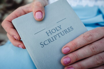 Young girl reads the scriptures or the Holy Bible. God's teachings according to belief and faith in God. Religion Concept - Image. The Holy Bible Gods word in scriptures. A book in the hands of a girl