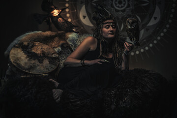 beautiful shamanic woman with owl in the interiors.