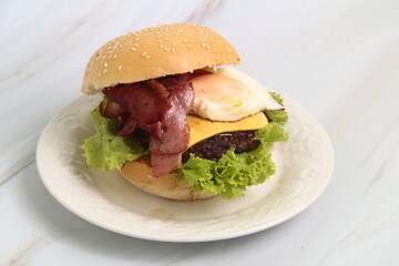 Freshly made giant hamburger sandwich with cheese and vegetables