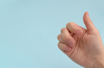 Broken finger.Arm injury after a fall.Injured painful finger after a fracture on a blue...