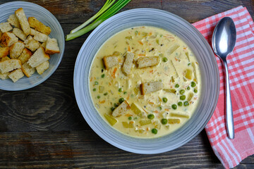 cheese soup with croutons on a wooden table. Healthy dietary vegetarian soup.
