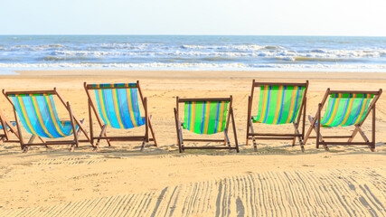 Colorful wooden bed bench or seat on the sand beach of sea or island.