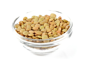 green lentils in a glass bowl isolated on white background