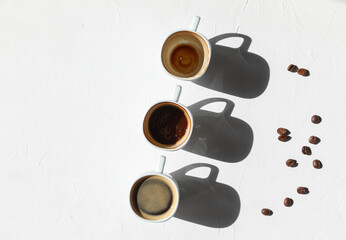 Three cups of coffee - full, half, and empty - coffee concept with copy space