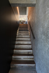 Fototapeta na wymiar Detail of modern monobloc staircase with bookcase and window on nature