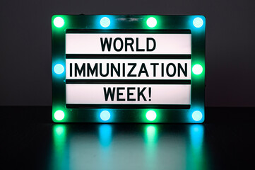 Lightbox with green lights with words - World immunization week!
