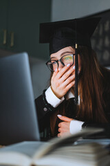 Happy young caucasian woman celebrating college graduation during a video call with friend or...