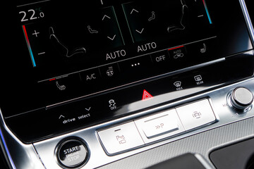 Air conditioning touch buttons inside a modern car. Climate control AC unit in the new car. Modern...