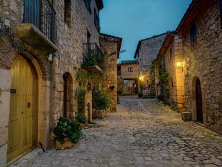 Street with stone houses of the beautiful town of Siurana at dusk, Province of Tarragona 