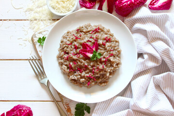 Traditional Italian ricotto with radicchio and parmesan cheese on white wooden background. Top view. Healthy food.