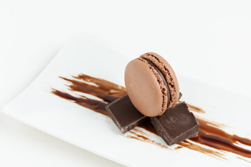 Chocolate macaroons dessert on white background.