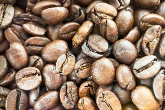 Roasted coffee beans background closeup.