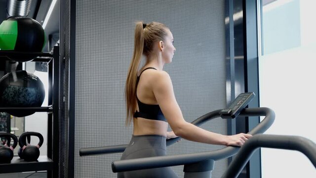 Sporty woman doing cardio on treadmill.